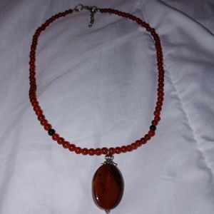 Red beaded necklace w/red stone pendant